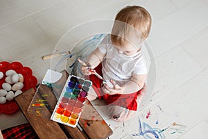 Smutty kid with watercolor paints photo