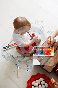 Smutty kid with watercolor paints photo
