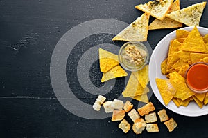 Snack for beer. Chips On a wooden background.