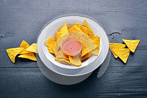 Snack for beer. Chips On a wooden background.