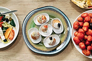 Snack cakes profiteroles with cream and salmon red fish. Top view