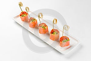 Snack canapes on a white glass plate. Catering service