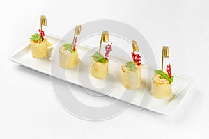Snack canapes on a white glass plate. Catering service