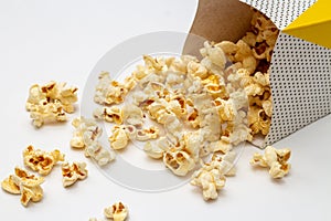 Snack concept, Sweet popcorn spilled out from two paper cup on white background