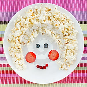 Snack or dessert for baby girl - sweet popcorn with strawberry a