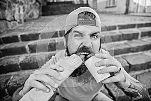 Snack for good mood. Guy eating hot dog. Street food concept. Man bearded eat tasty sausage and drink paper cup. Urban