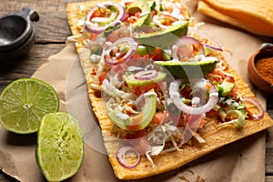 Snack made with wheat flour called chicharron preparado with sauce and vegetables. Mexican food photo