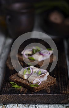 Snack of rye bread, herring and onions