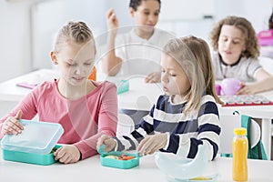 Snack time in a kindergarten class. Children opening their mint