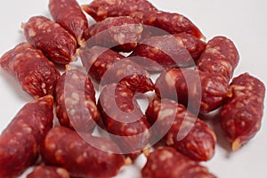 Snack to beer. Small sausages to frothy drink. Background of sausages on a light background close up