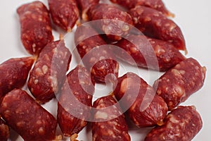 Snack to beer. Small sausages to frothy drink. Background of sausages on a light background close up