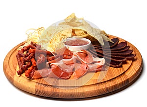 Snack to beer on a wooden board. Basturma, dried meat, dried squid, chips isolated on white background