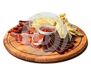 Snack to beer on a wooden board. Basturma, dried meat, dried squid, chips isolated on white background