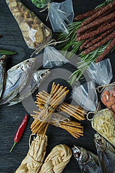 Snacks for beer, nuts and crackers. Beer snacks are packed in cellophane. Dark wooden background