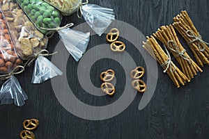 Snacks for beer, nuts and crackers. Oktober Fest. Beer snacks. Dark wooden background. Space for text