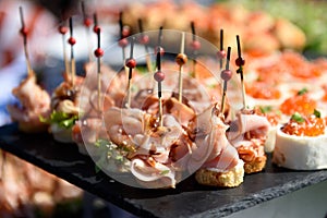 Snacks and canapes and tartlets stuffed in the assortment on the buffet table.