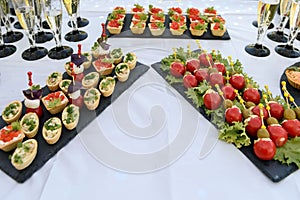 Snacks and canapes and tartlets stuffed in the assortment on the buffet table.