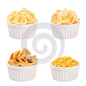 Snacks collection - crunchy different corn sticks in white ceramics bowls, isolated. Fast food template for menu, advertising, cov