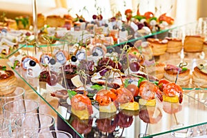 Snacks, fish and meat specialities on the buffet. Desserts. A gala reception. Served tables. Catering