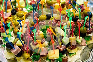 Snacks on skewers on the buffet table.