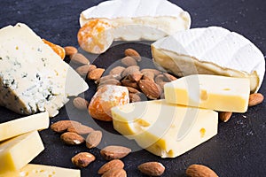 Snacks with wine - various types of cheeses, figs, nuts, honey, grapes