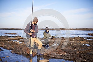Snail fishing. Shot of a father and son out fishing together by the sea.