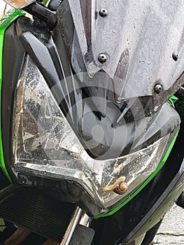 Snail sitting on beautiful green Kawasaki motorcycle