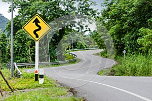 Snake curved road and warning sign