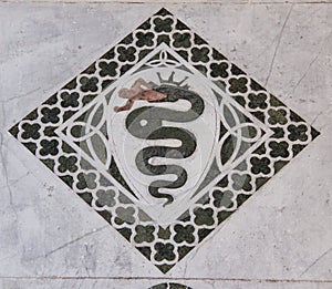 Snake eating a man in a decorative quad on the Chiesa dei Santi Giovanni e Reparata