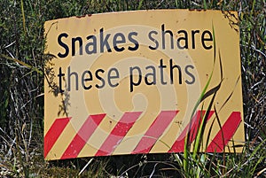 Snakes share these paths warning sign