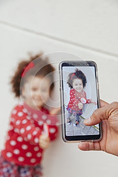 Snap shot of a little girl with a smartphone