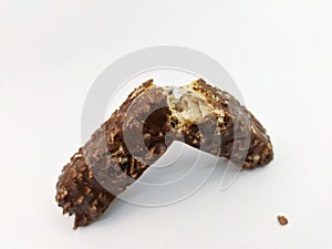 Snapped chocolate-coated melting caramel and rice crispy wafer