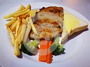 snapper fish beef and Pork Chop Steak grilled with butter bread potato fried and vegetable