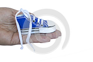 Sneaker on the palm isolated on a white background. Fashionable stylish sports casual shoes. Creative minimalistic layout with