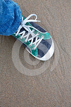 Sneaker on sand. Top view sneakers close up