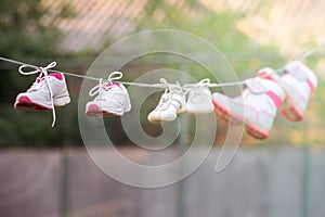 sneakers dried on a rope in the summer garden