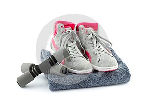 Sneakers with dumbbells and towel