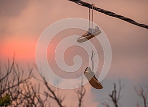 Sneakers hanging from overhead wires