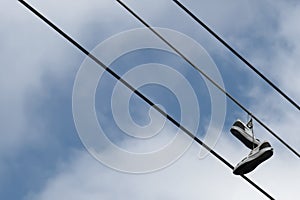 Sneakers hanging from wire