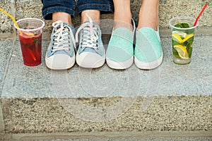 Sneakers, moccasins and cold drink