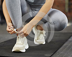 Sneakers, shoelaces and tying for fitness, gym and workout start for health and wellness. Athlete, cardio and warmup for