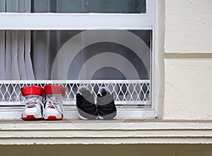 Sneakers in the window of an old house