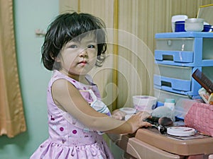 Sneaky baby girl, 2 years old, is about to put on / use her mom`s cosmetics - child playing make up