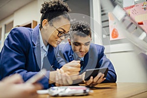 Sneaky Students Using Smartphone In Lesson