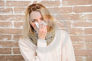 Sneezing just keep coming. Sick woman blowing her nose in napkin. Pretty girl sneezing of seasonal influenza virus. Cute