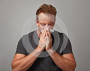 Sneezing man with cold