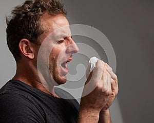 Sneezing man with cold