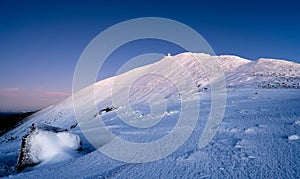 Sniezka mountain at dusk during winter in Giant mountains