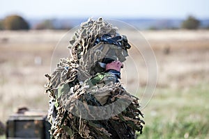 Sniper in the field camouflage before the fight