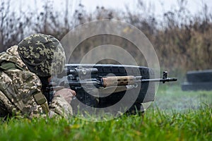 Sniper operator in camouflage uniform